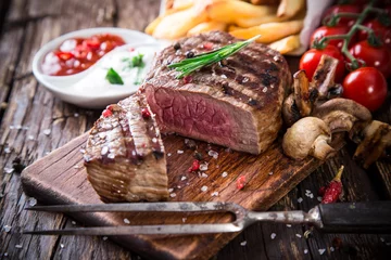 Foto op Plexiglas Beef steak on wooden table © Lukas Gojda