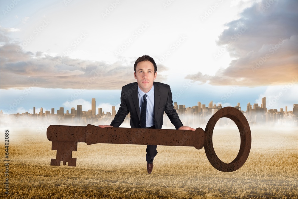 Poster composite image of businessman carrying large key