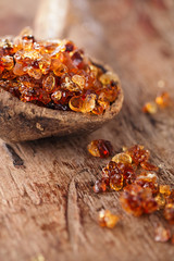 Gum arabic, also known as acacia gum - in  old wooden spoon