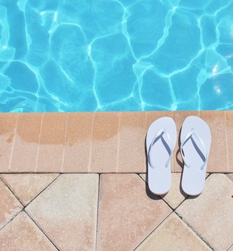 Poolside vacation scenic flip flops thongs background copy space holiday stock photo photograph image picture 