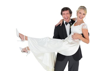 Happy groom carrying bride