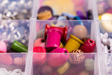 Multicolored beads and buttons set in a box. Hand made jewelry
