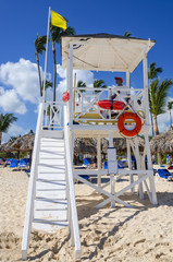 Colorful lifeguard observation  tower on sandy Caribbean beach - 64410483