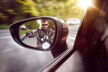 Biker in rear view mirror