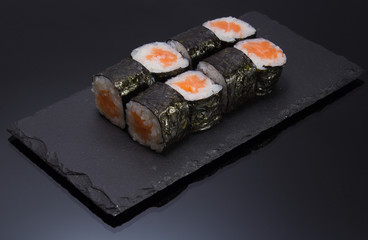 sushi mde dish over black background