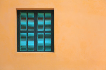 Green windows on orange wall