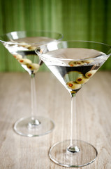 Two olive martini cocktails