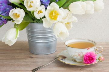 vintage cup of tea with tulips