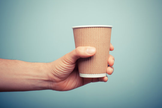 Man holding paper cup
