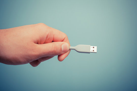 Hand holding usb cable