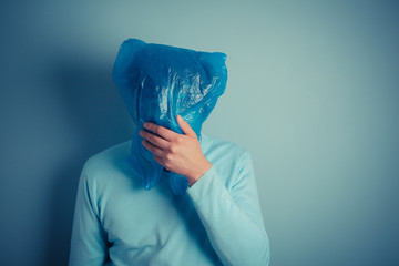 Man with a plastic bag over his head