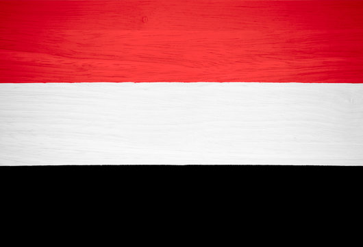 Yemen flag on wood texture