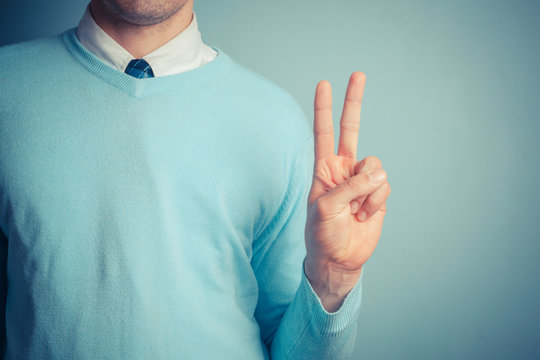 Man giving peace sign