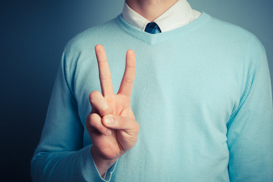 Man giving peace sign