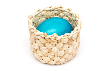 Fototapeta na wymiar Blue Easter Egg In Small Wood Basket Isolated