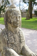 Fototapeta na wymiar Stone Sphinx in the Garden