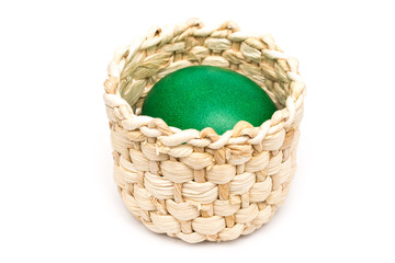 Green Easter Egg In Small Wood Basket Isolated