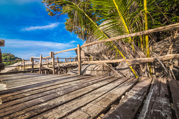 platform beside sea with coconut tree