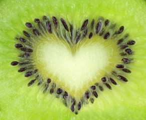 Kiwi fruit slice texture with heart shape. Extreme macro shot.