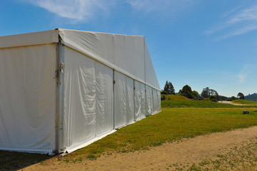 Large white party tent if a field