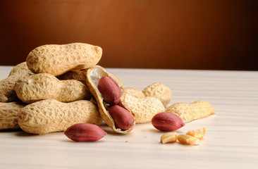 group of peanuts on the table and brown background