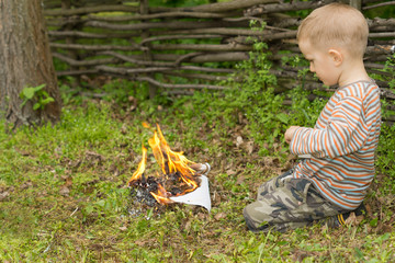 Little boy playing with fire
