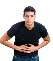 Young man having stomach upset, pain, holding belly 