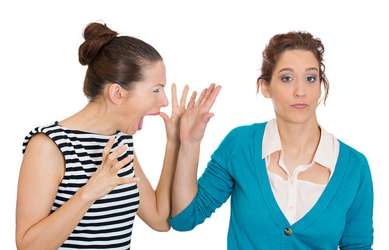Woman giving talk to the hand to angry screaming girl 