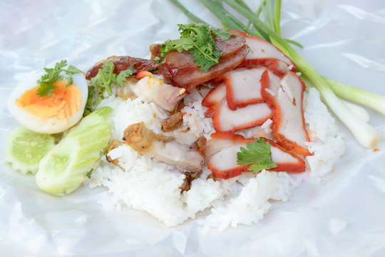 'red' pork with rice on Paper plate