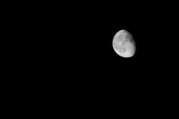 Partial moon, isolated on black. 