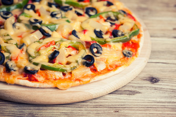 Delicious italian pizza served on wooden table