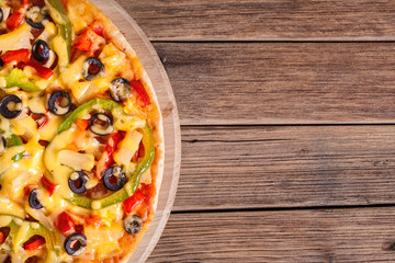 Obraz na płótnie Canvas Delicious italian pizza served on wooden table