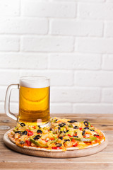 pizza on the table with a glass of beer