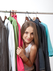 Young woman near rack with hangers