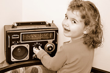 Sweet young girl and retro dusty radio