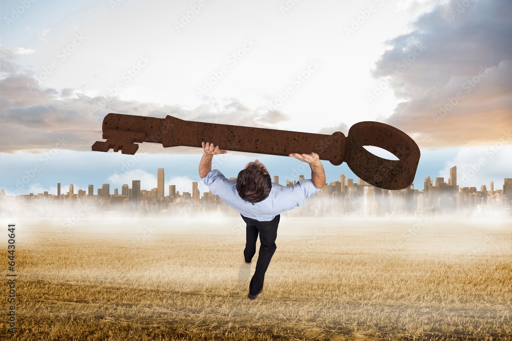 Poster composite image of businessman carrying large key