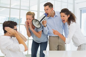 Casual business team shouting at a colleague