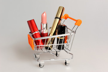 Makeup in pushcart on gray