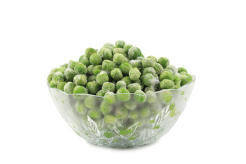 Green frozen peas in a glass dish.