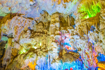 Famous cave in Halong bay illuminated by colorful lights
