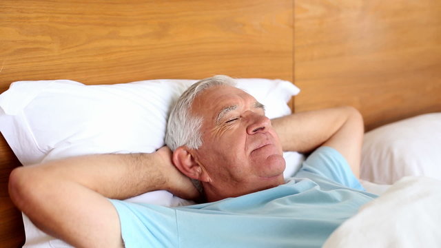 Senior man lying in bed sleeping