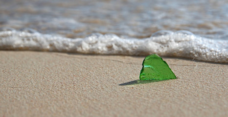 Single Green Sea Glass on the Shore