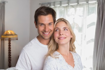 Smiling young couple together at home