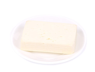 Tofu cheese on white plate.