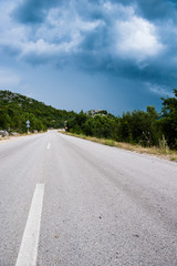 Fototapeta premium Lonely road in the countryside and cloudy weather