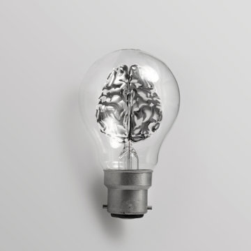 3d metal human brain in a lightbulb as creative concept