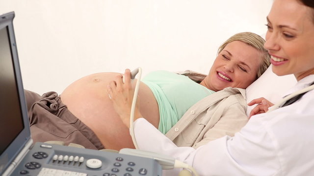Pregnant woman having a sonagram scan