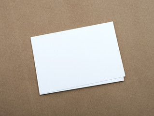 Stack of blank white business cards on crafts background