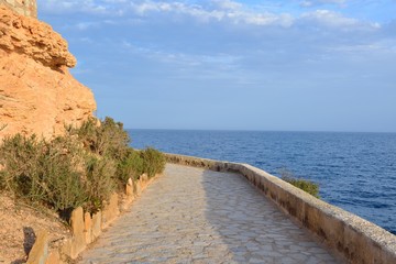 Paved coastal walkway on a summer evening, Cabo Roig, Spain
