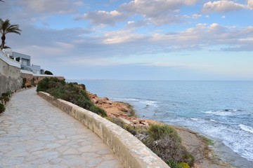 Paved coastal walkway on a summer evening, Cabo Roig, Spain